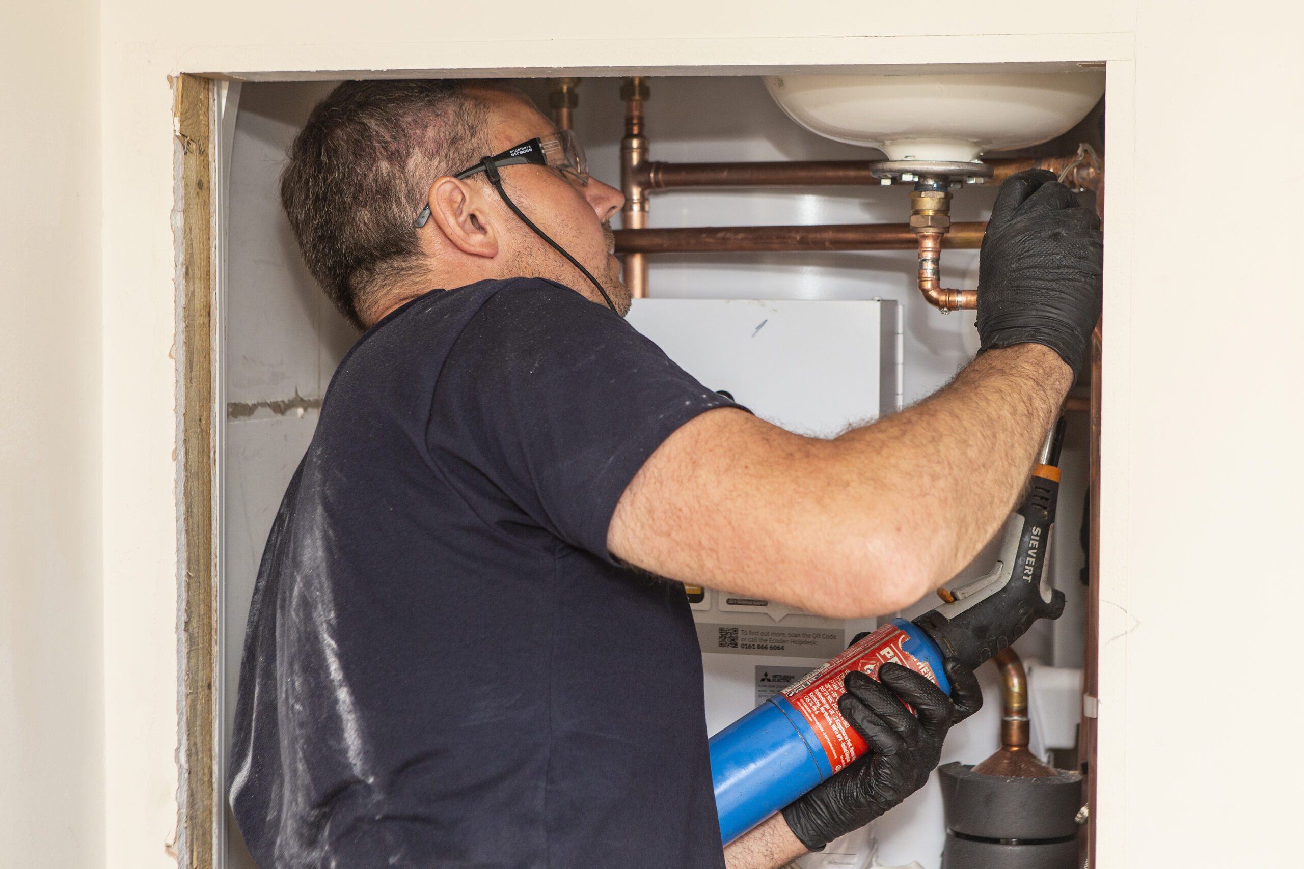Installer looks at pipe work