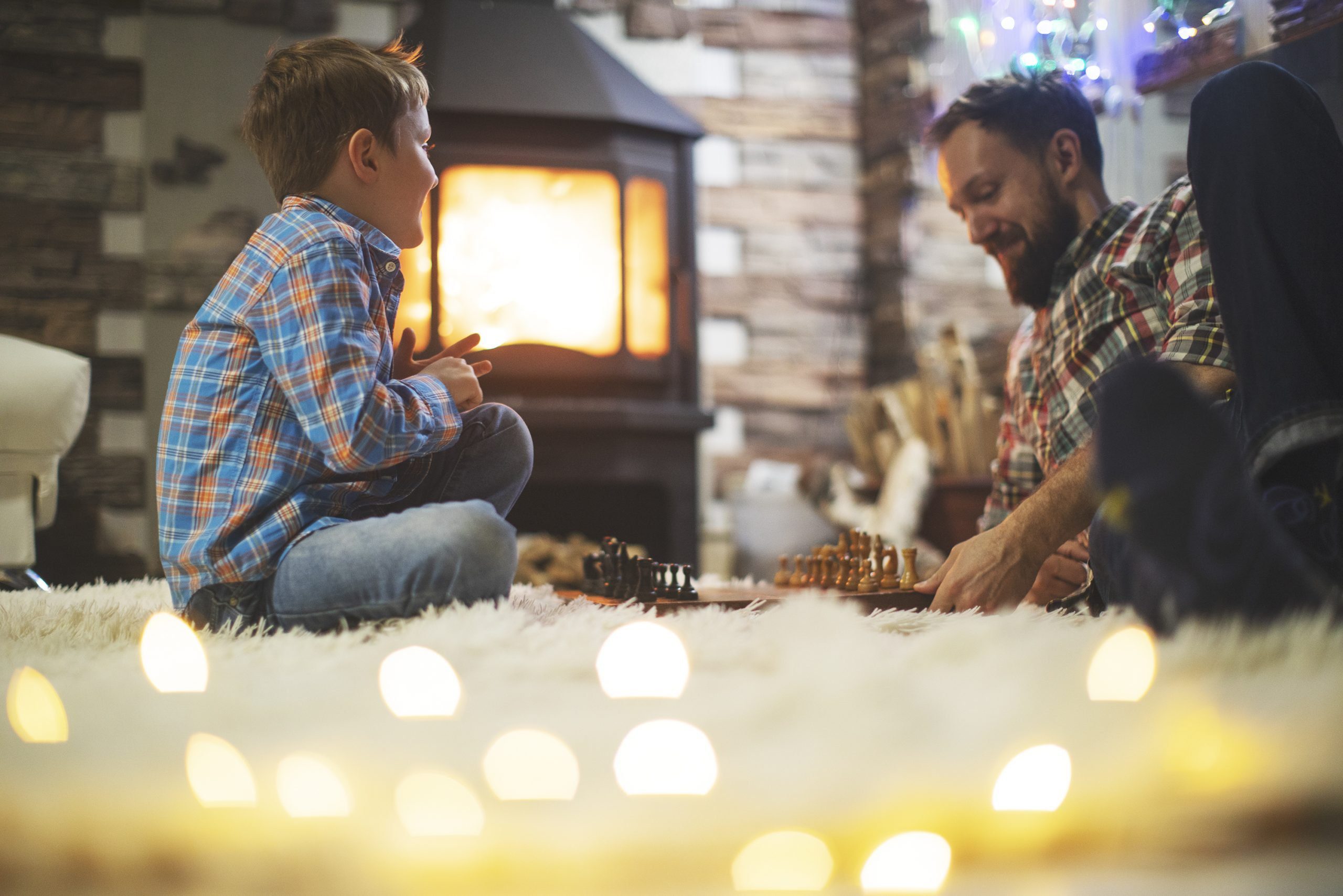 Father and son enjoying Christmas holidays at home after benefiting from Christmas energy saving tips.