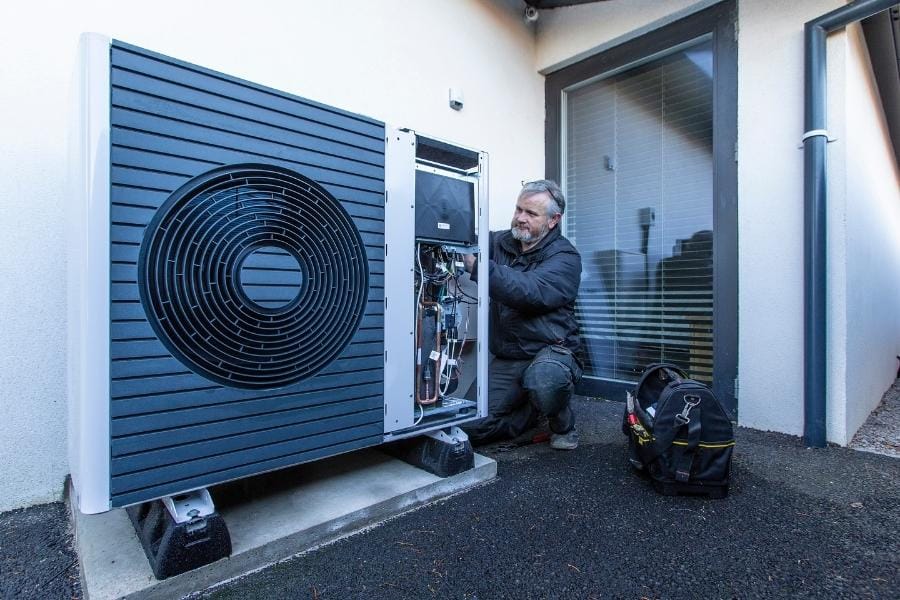 A member of the Green Heat Installer Engagement Programme installing an air sourc eheat pump.
