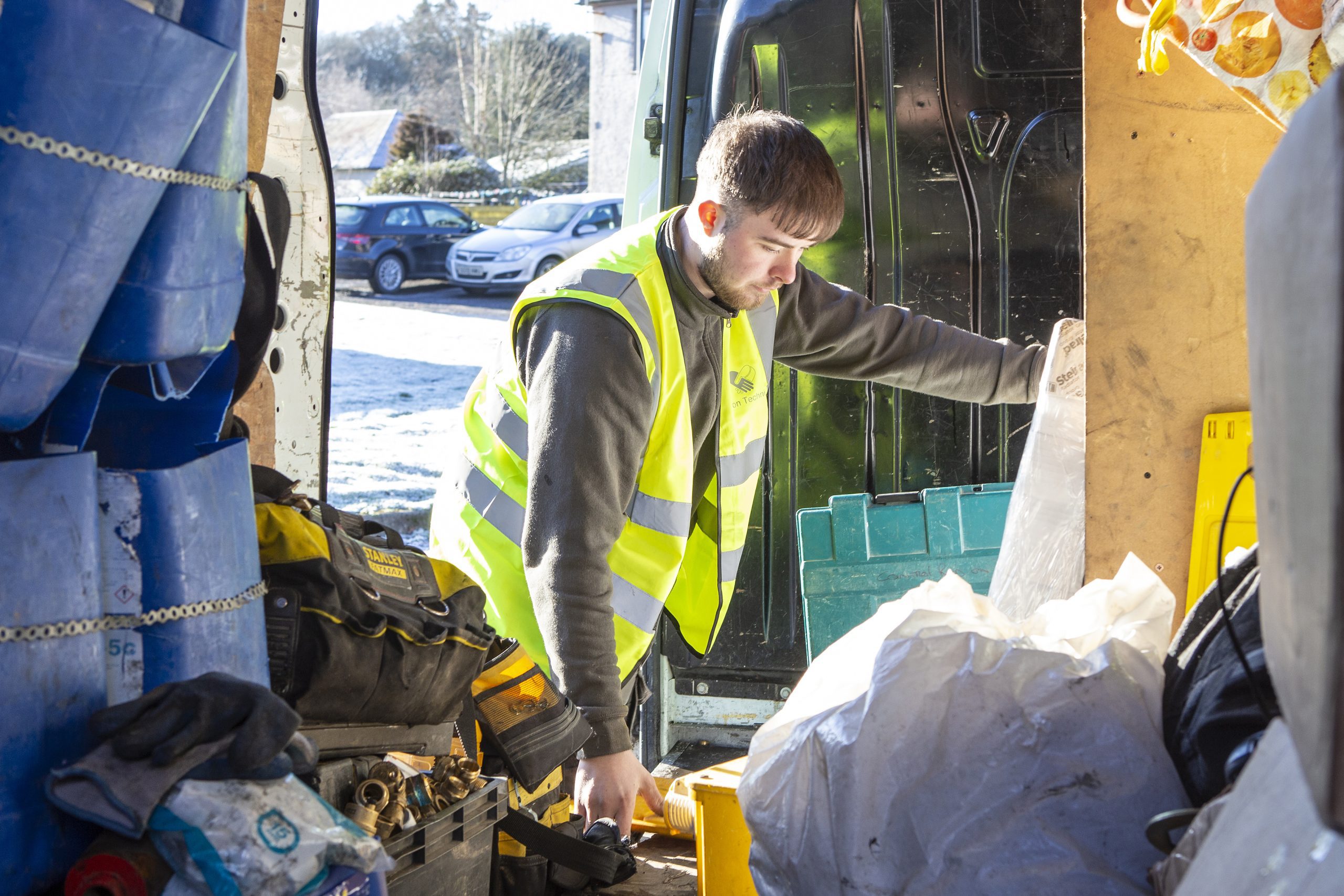 installer looking in the back of tool van