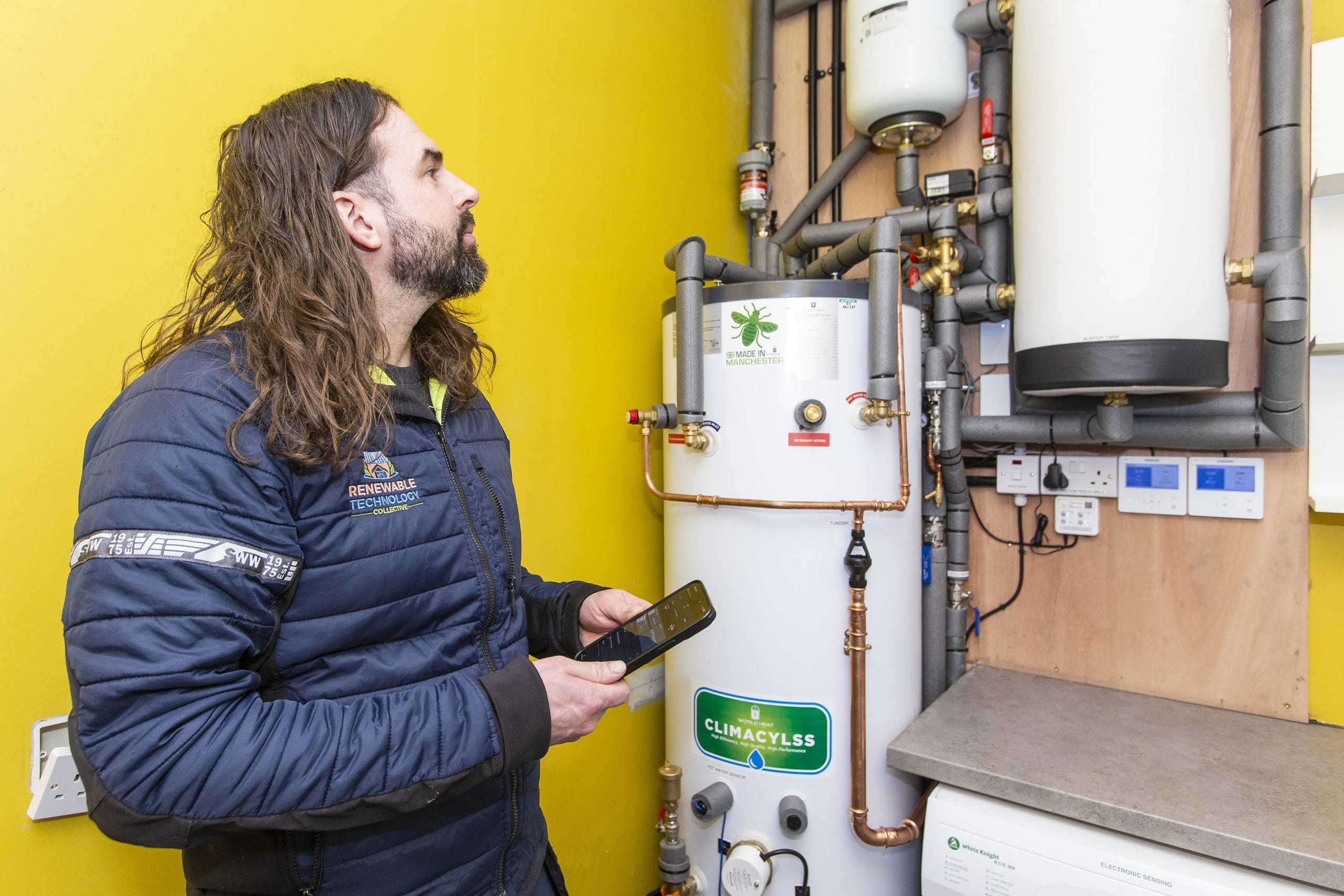 Installer inspects hot water tank